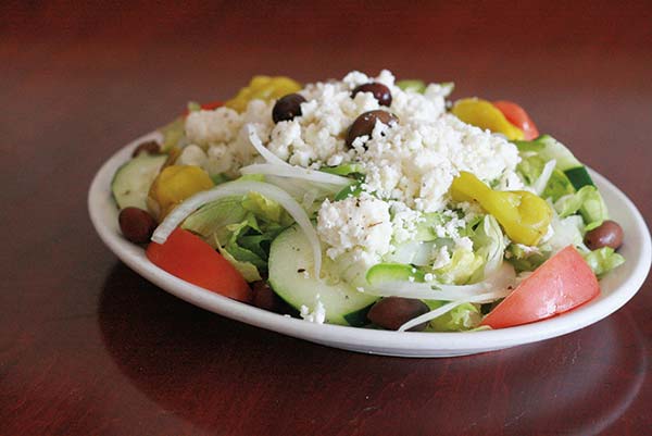 A salad with feta cheese on it and no dressing