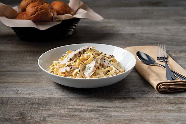 Fettucine with chicken and a fork and spoon